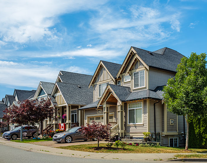 A Perfect Neighborhood In Canada. Houses In Suburb At Summer With Nicely Landscaped Front Yard And Driveway To Garage A Perfect Neighborhood In Canada. Houses In Suburb At Summer With Nicely Landscaped Front Yard And Driveway To Garage